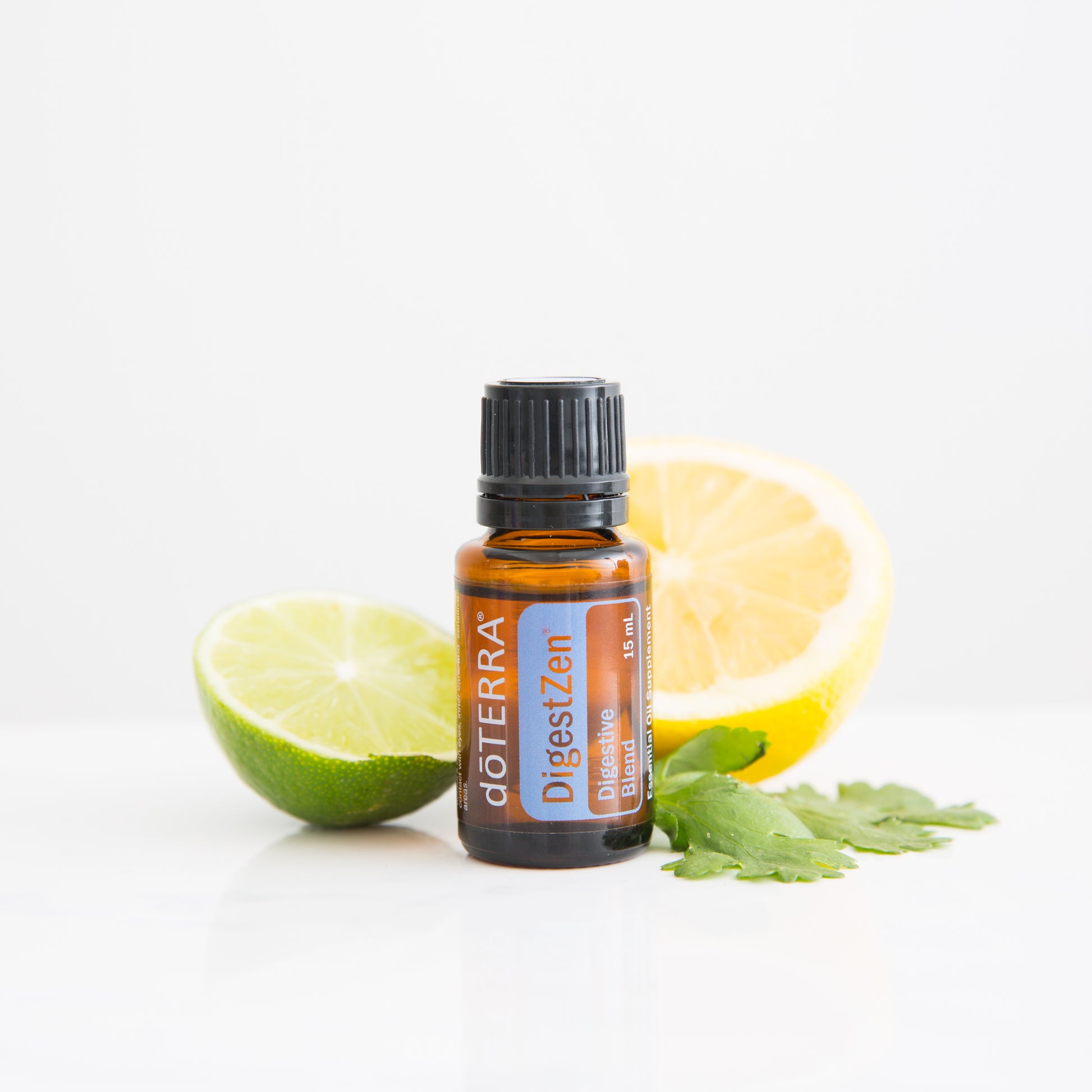 doTERRA DigestZen essential oil bottle with a lemon and lime on a white background