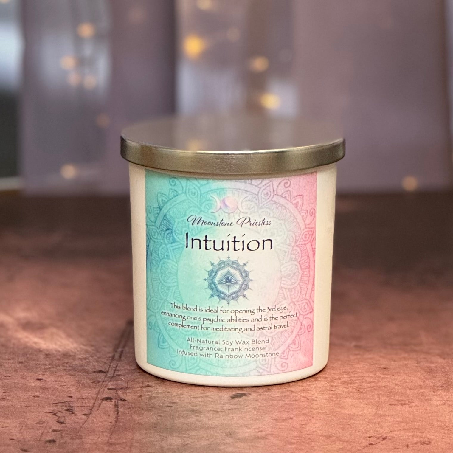 Candle with 'Intuition' label on a wooden surface