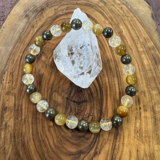 Beaded bracelet with multicolored beads and a crystal on a wooden surface