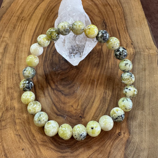 Beaded bracelet with yellow and black beads on a wooden surface