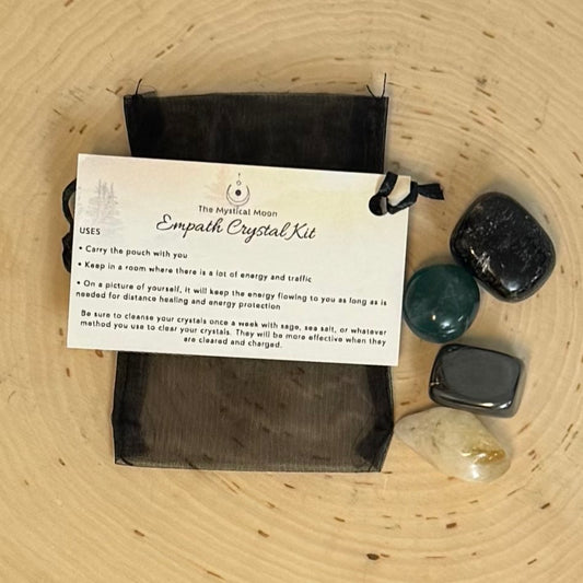 Empath Crystal Kit with stones and instructions on a wooden surface