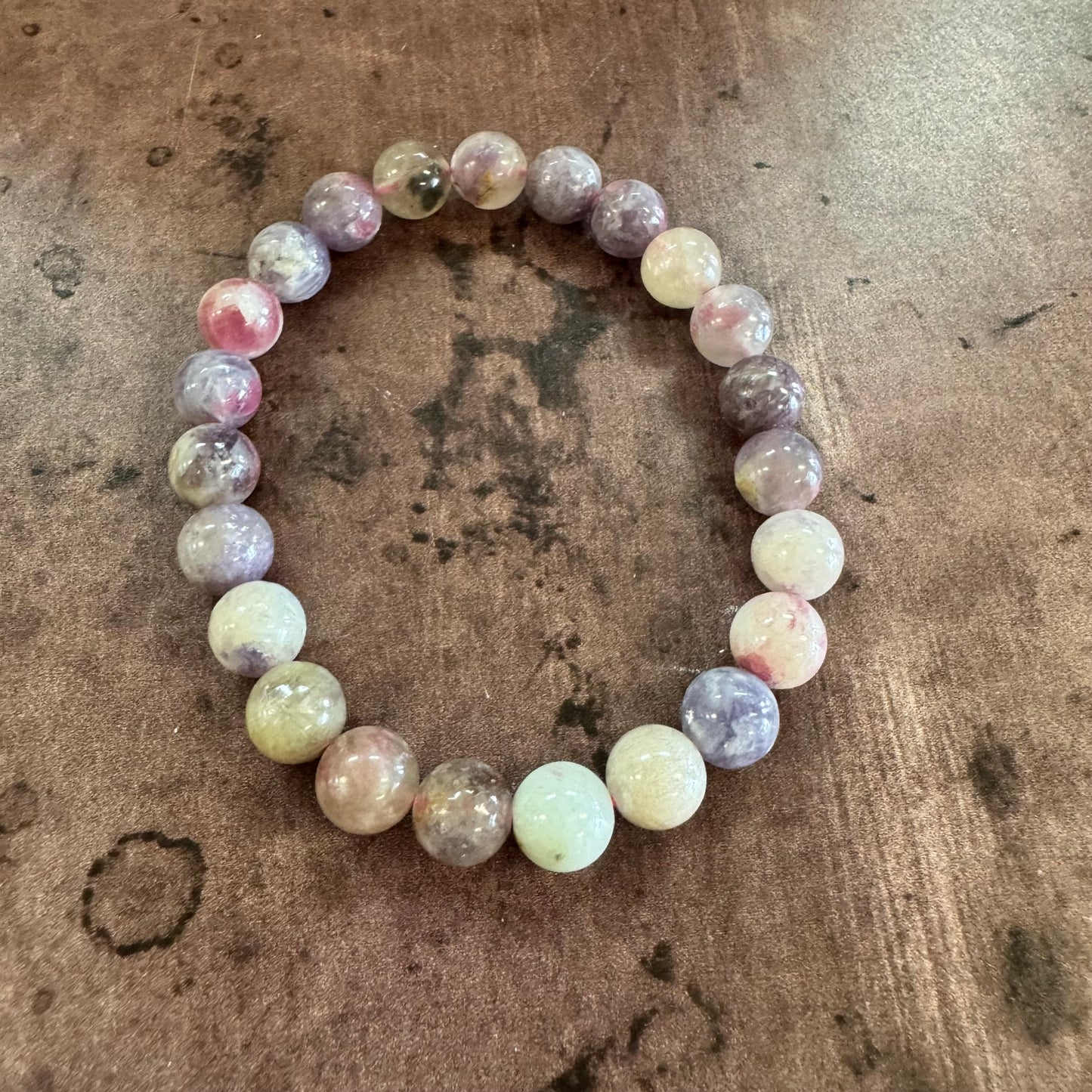 Multicolored beaded bracelet on a textured brown surface