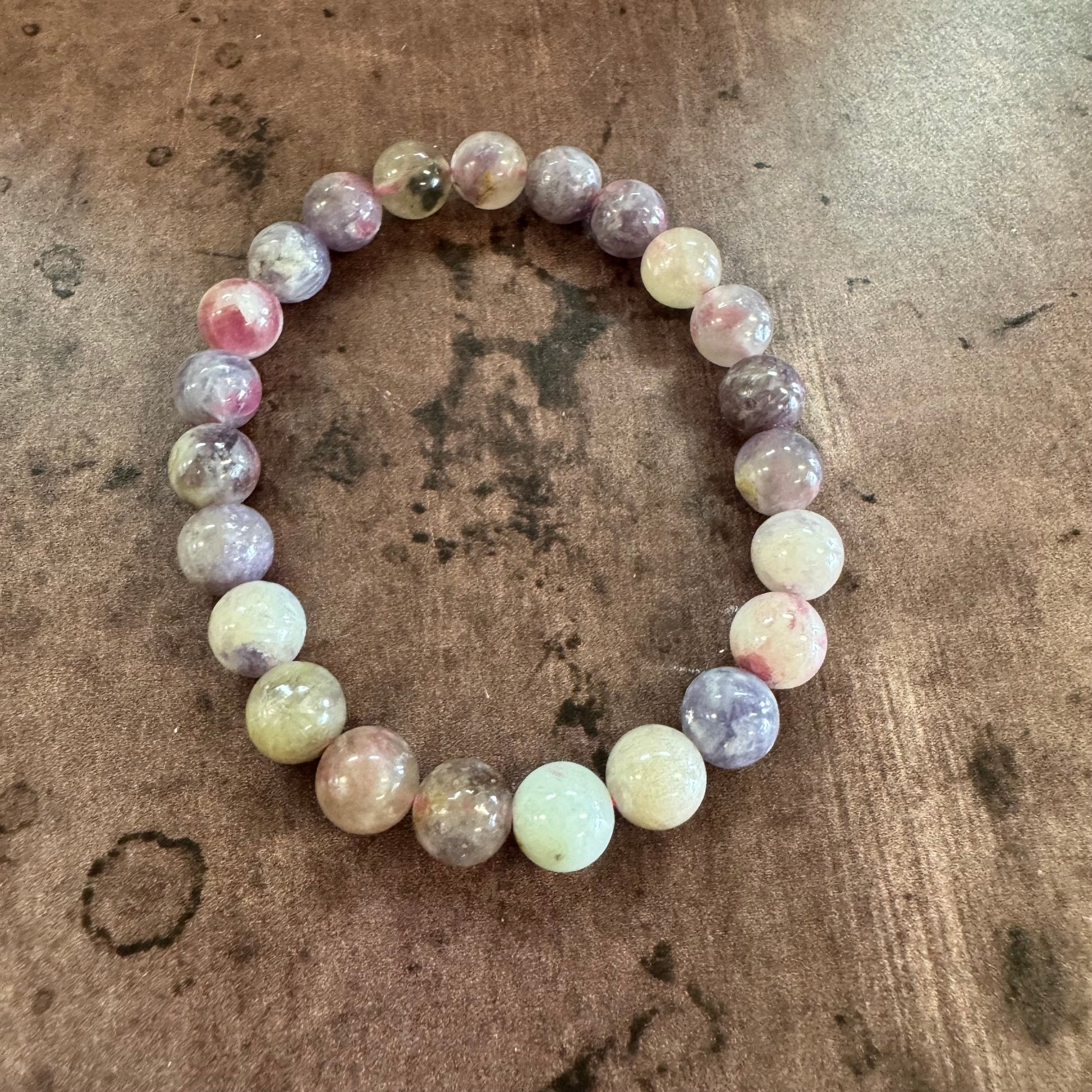 Multicolored beaded bracelet on a textured brown surface