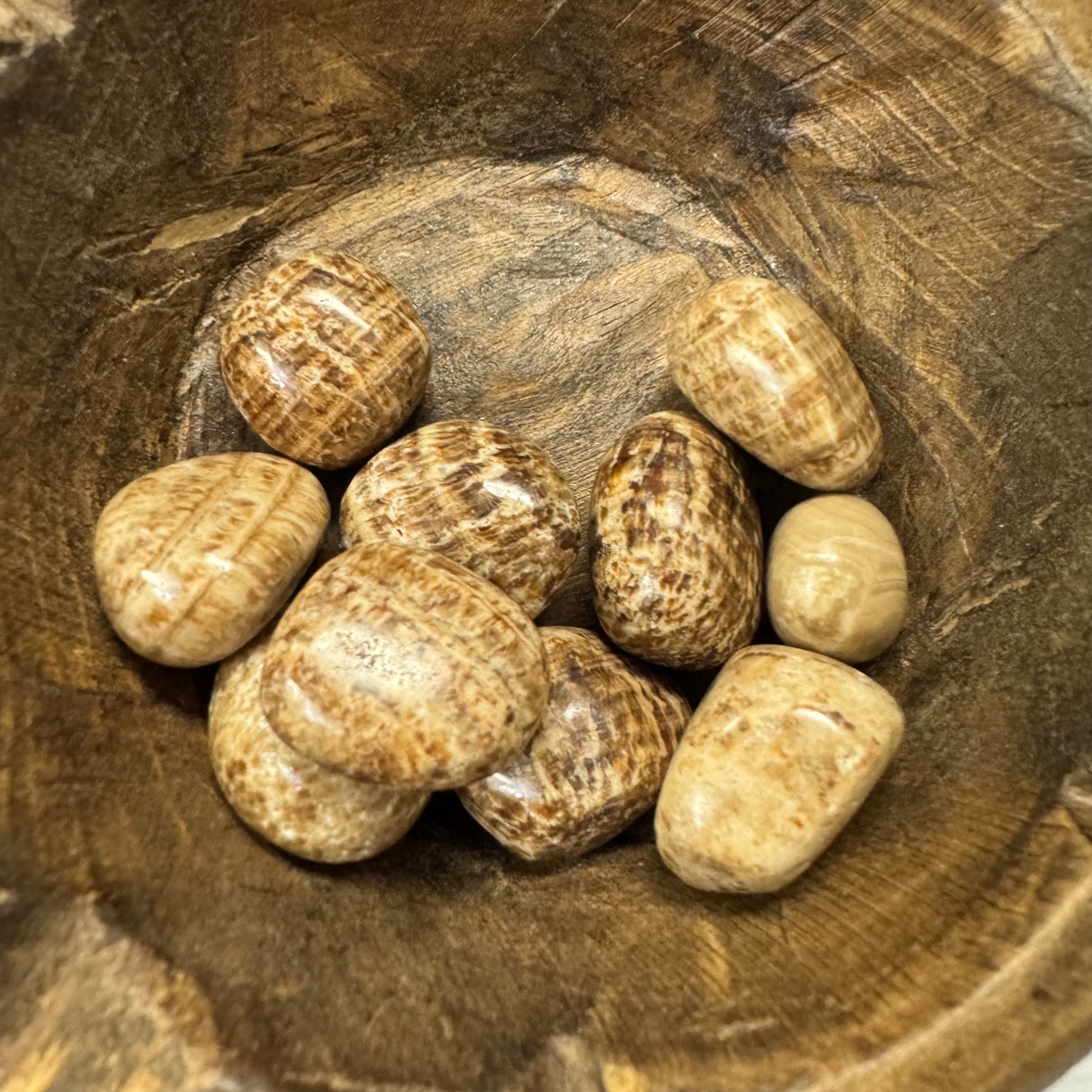 Brown stones in a wooden bowl