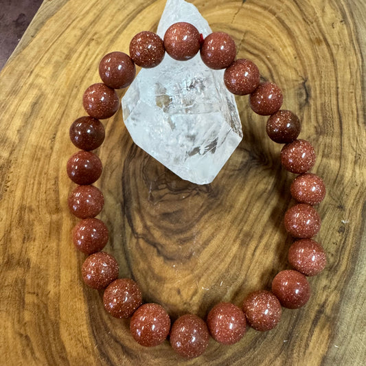Bracelet with red beads on a wooden surface