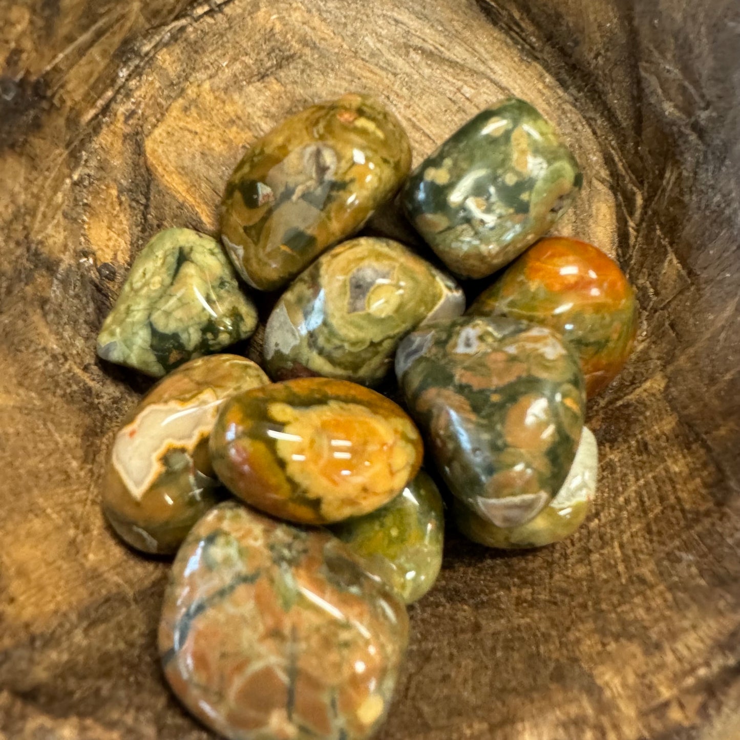 Collection of marbled stones on a wooden surface