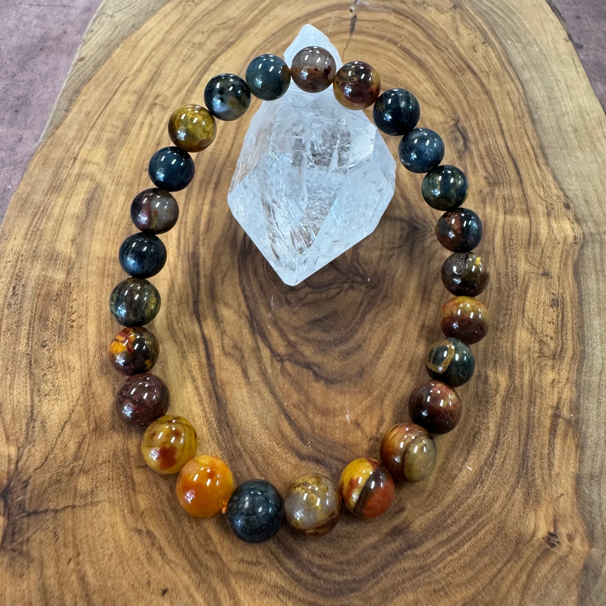 Gemstone bracelet with multicolored beads on a wooden surface