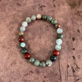 Multicolored beaded bracelet on a textured brown surface