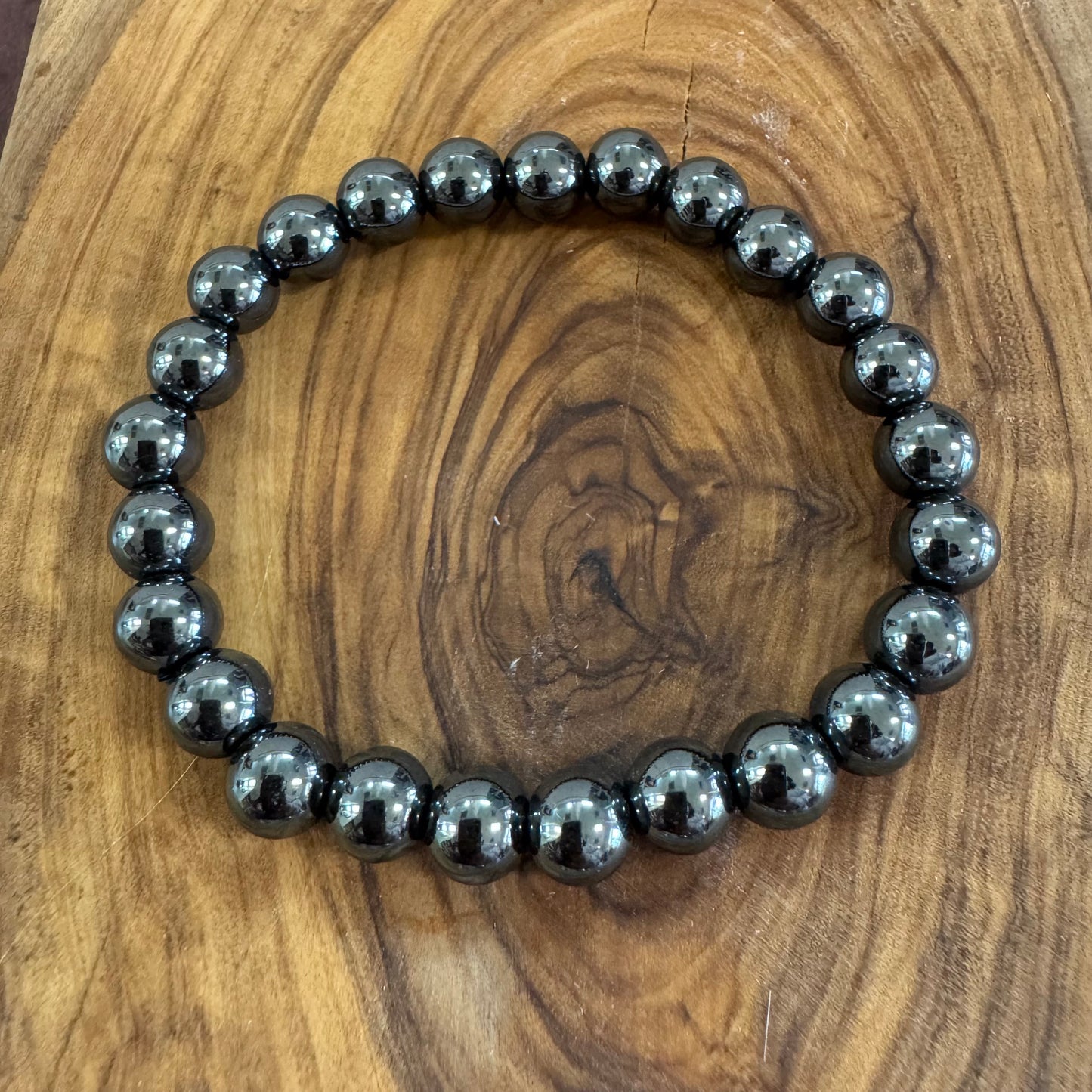 Black beaded bracelet on a wooden surface