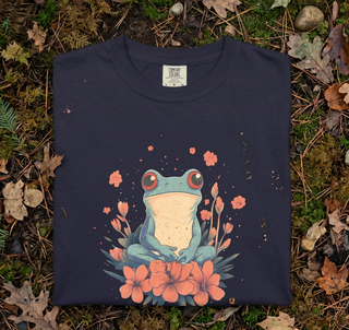 Folded True Navy frog in flowers cottagecore t-shirt resting on green grass