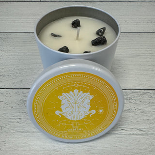 A candle with lavender and eucalyptus fragrance, embedded with larvikite crystals, and a label featuring the Gemini zodiac sign.