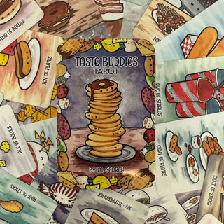 A spread of illustrated tarot cards from the Taste Buddies Tarot deck, with the central card showing a tall stack of pancakes and the title 'Taste Buddies Tarot' by M. Spector.