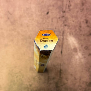 A hexagonal box of Soly's Honey Drawing Sweet White sugar, photographed from a high-angle perspective on a textured, warm-toned surface.