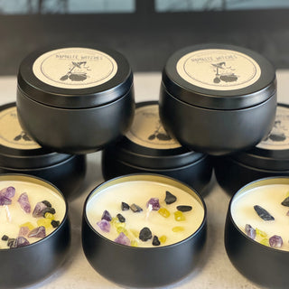 Close up of candle with black tin and crystals