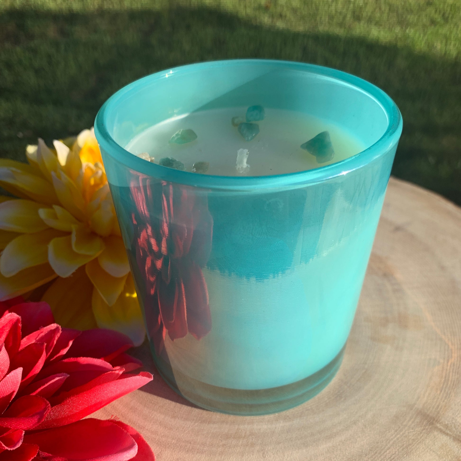 🕯️This photo displays the aqua-colored mermaid jar representing mysticism, intuition and connection to the divine feminine with amazonite, known as the stone of courage and truth that enhances communication and expressions of the heart.🕯️