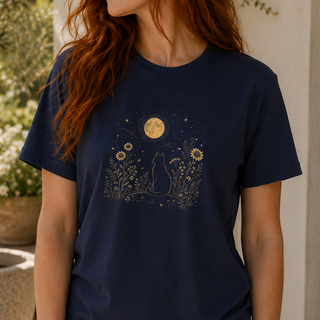 Navy Moonlit Cat tee with a gold cat among wildflowers under a full moon, worn outdoors