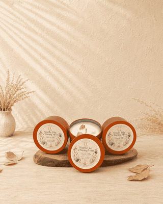 Smells Like a Waxing Moon Harvest Moon candles by The Mystical Moon, displayed in warm terracotta tins on a wooden board with dried botanicals and autumn leaves