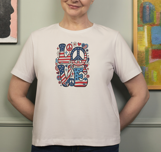 Natural Patriotic LOVE peace sign t-shirt worn by a person in front of framed artwork, colorful LOVE graphic