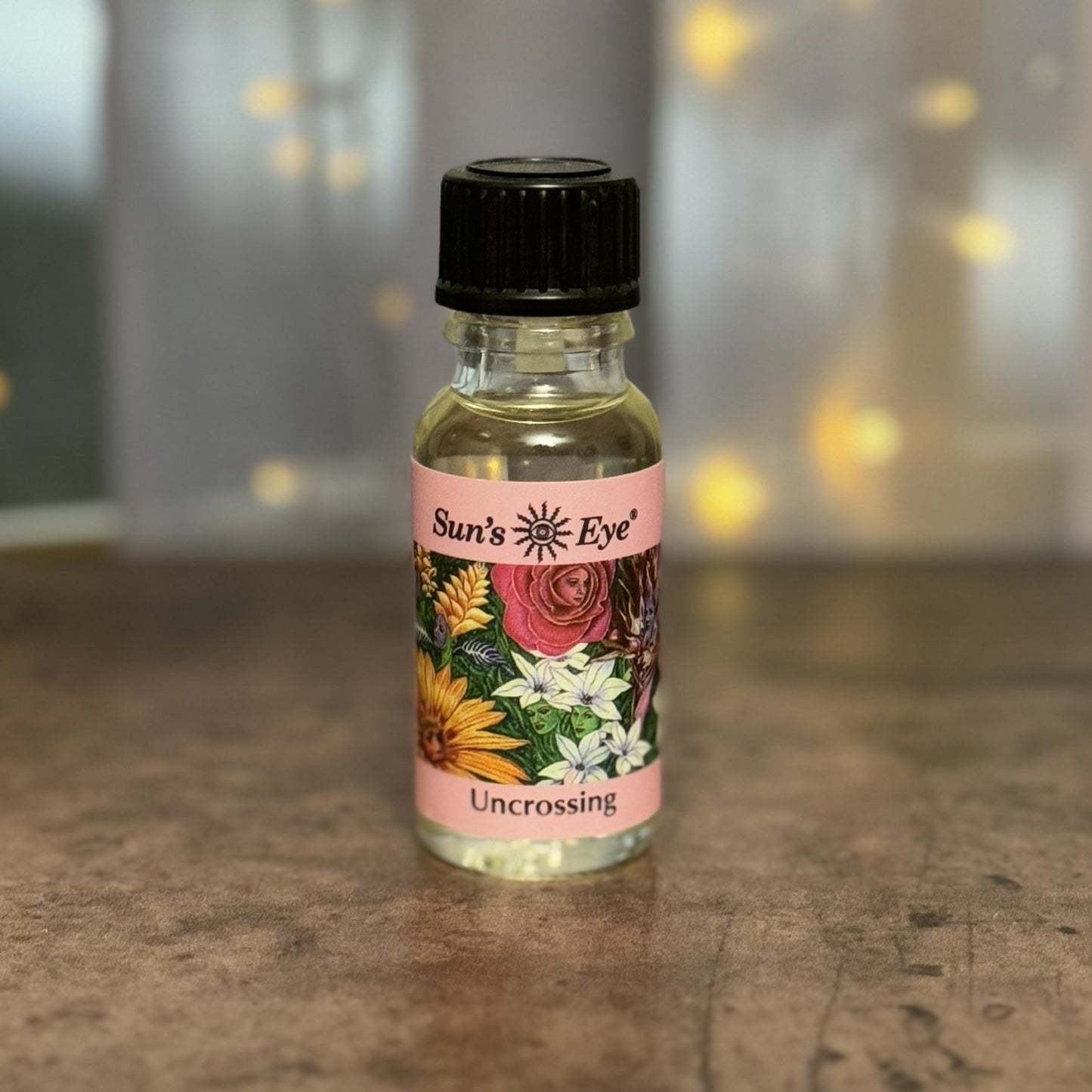 Bottle of 'Sun's Eye Uncrossing' on a countertop with a blurred background