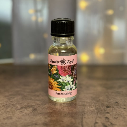 Bottle of 'Sun's Eye Uncrossing' on a countertop with a blurred background