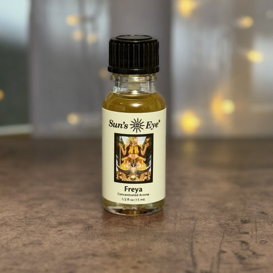 Bottle of Sun's Eye Freya concentrated aroma on a textured surface with blurred lights in the background