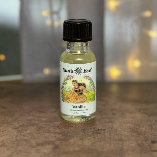 Small bottle of Vanilla Oil with a label featuring an illustration on a textured surface.