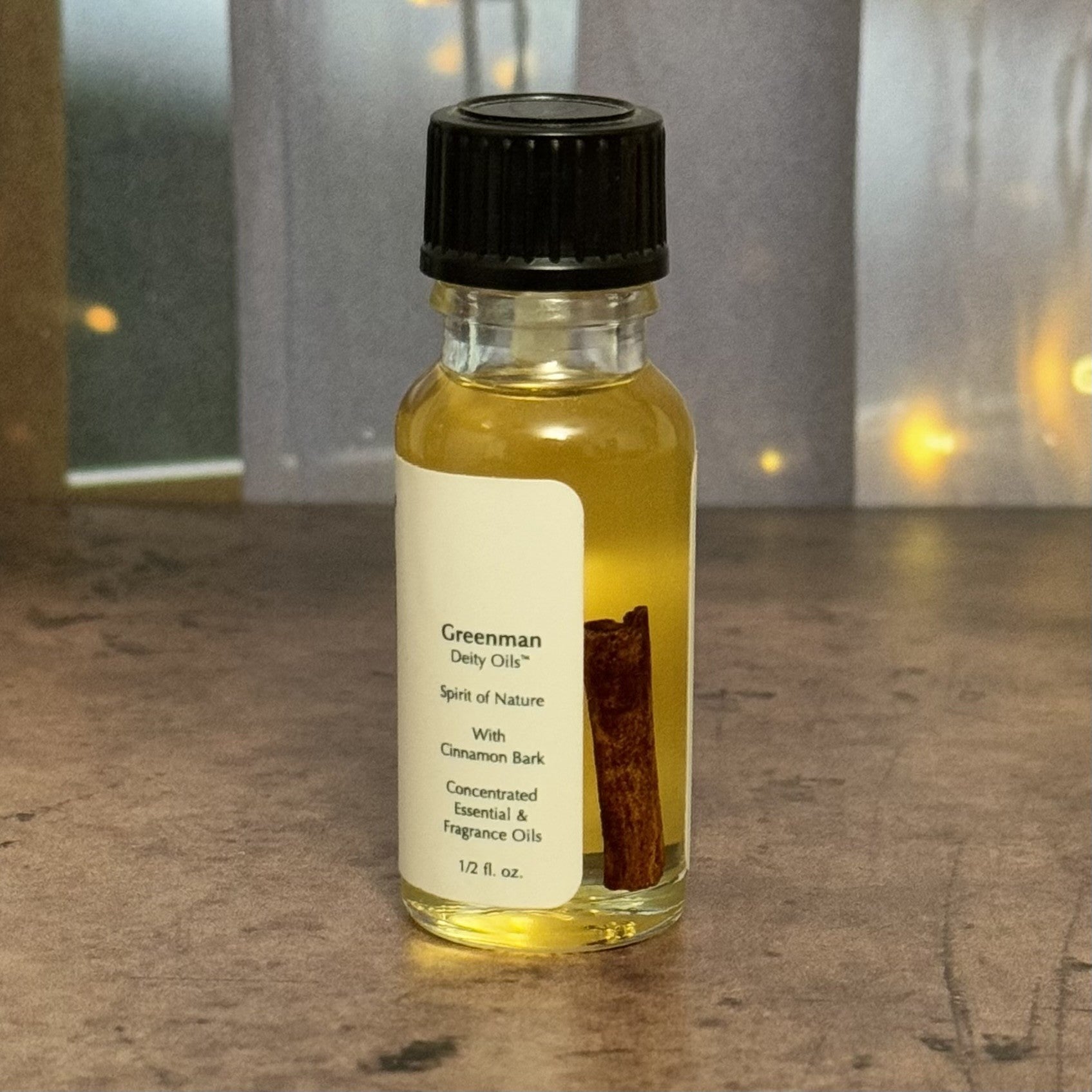 Small bottle of Greenman Daily Oil with a label on a textured surface