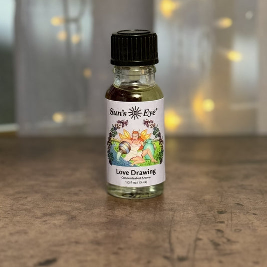 Bottle of 'Love Drawing' with a colorful label on a wooden surface.