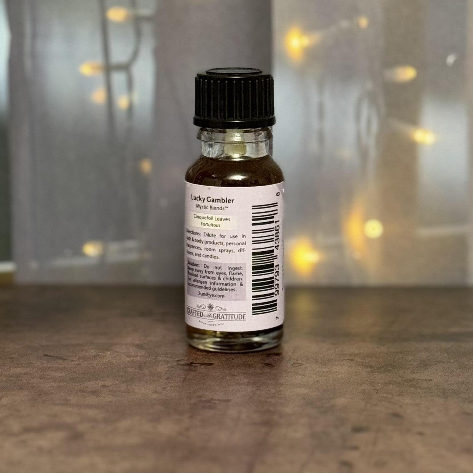 Small bottle with a label on a reflective surface