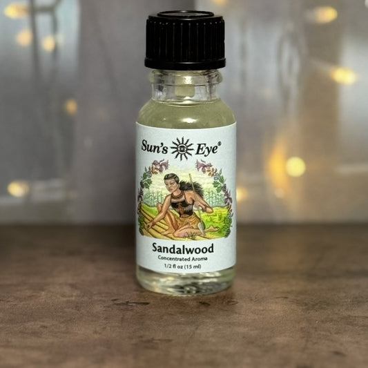 Bottle of Sun's Eye Sandalwood oil with a blurred background