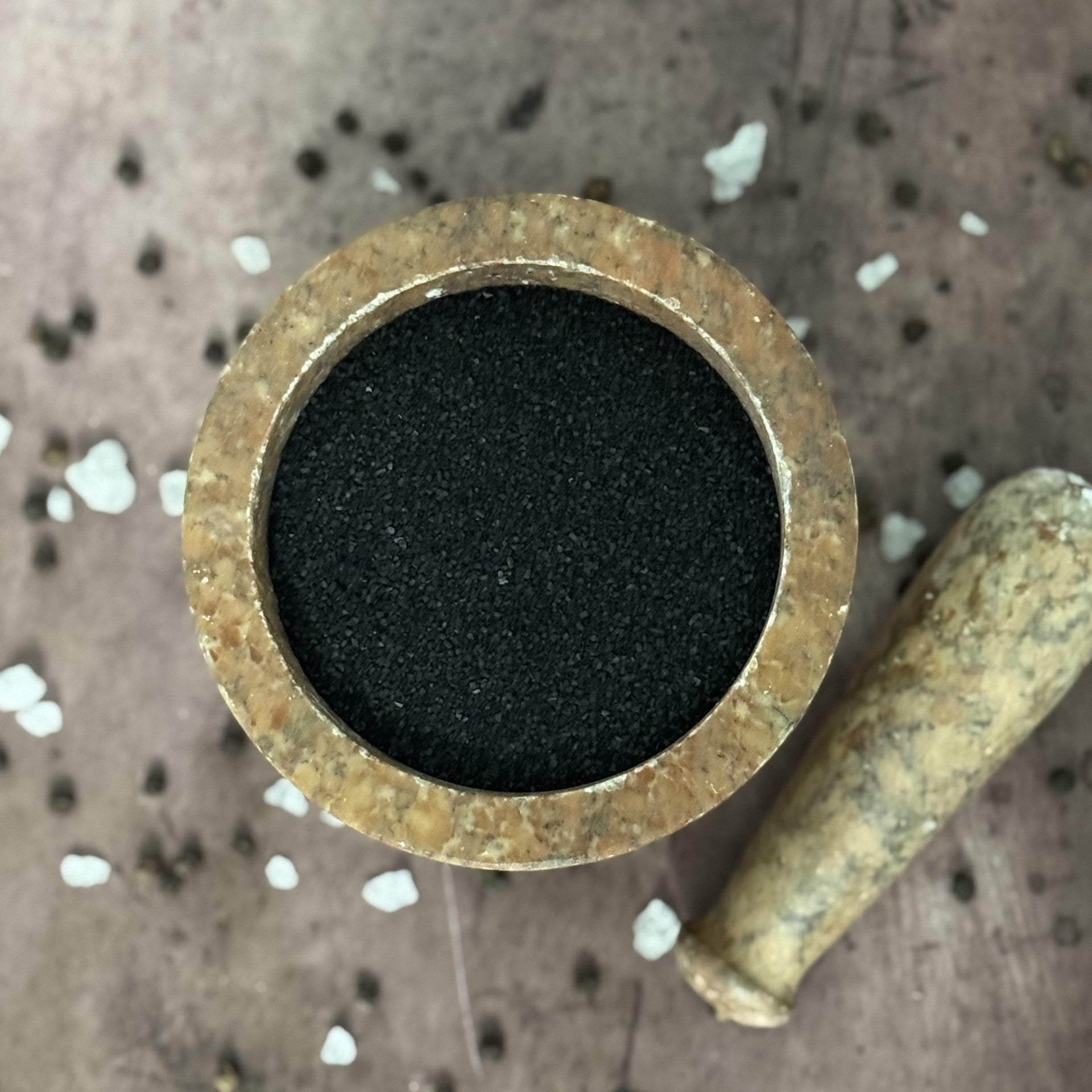 Brass fitting with black rubber washer on a textured surface