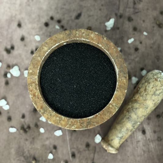 Brass fitting with black rubber washer on a textured surface