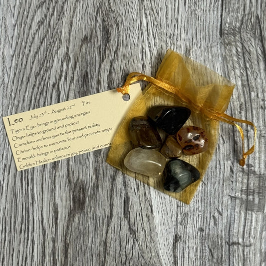 Set of stones in a drawstring bag with a tag on a wooden surface
