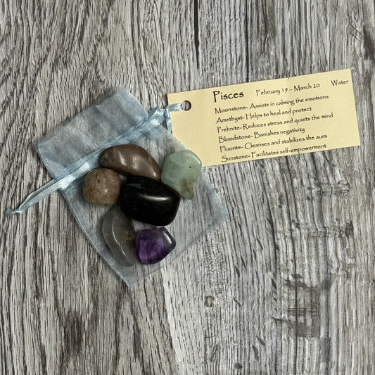 Set of stones in a clear bag with a label on a wooden surface