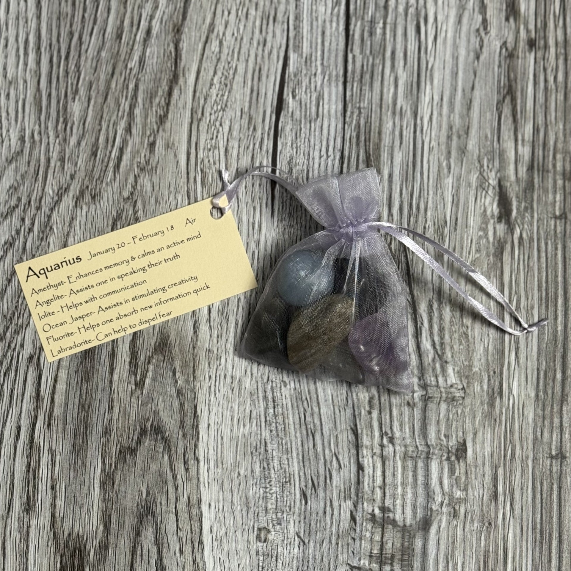 Bag of stones with a label on a wooden surface
