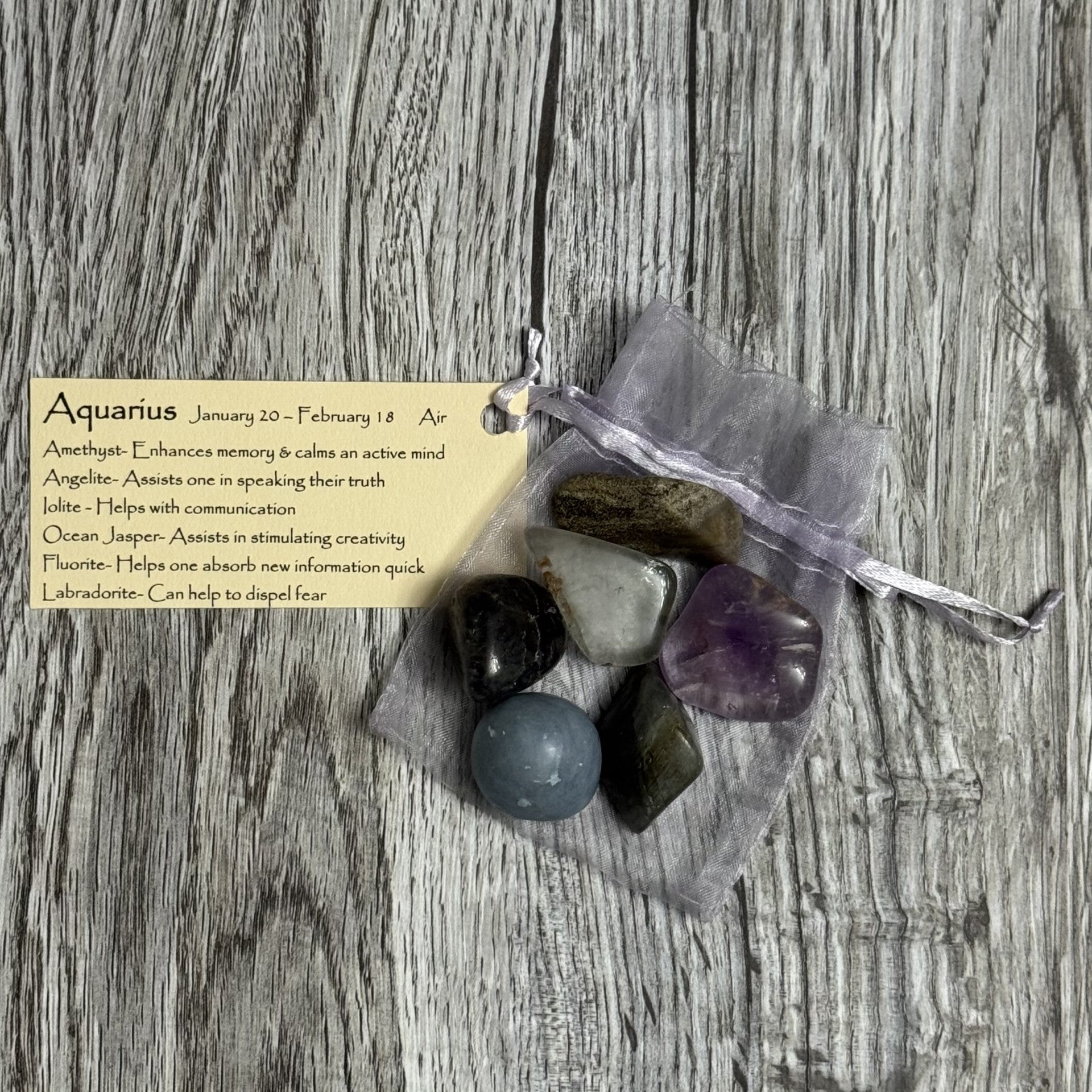 Bag of stones with a card on a wooden surface