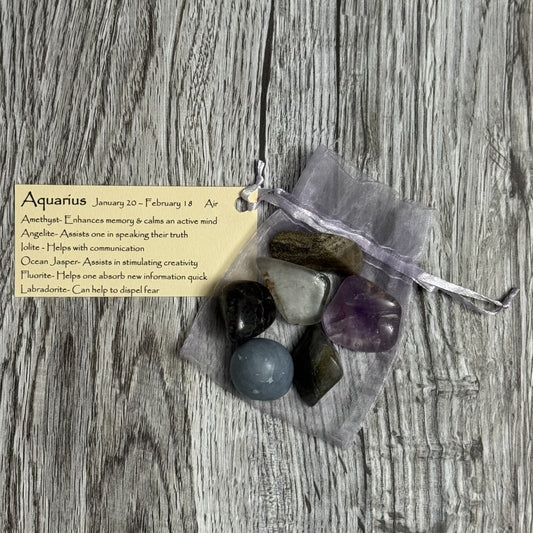 Bag of stones with a card on a wooden surface