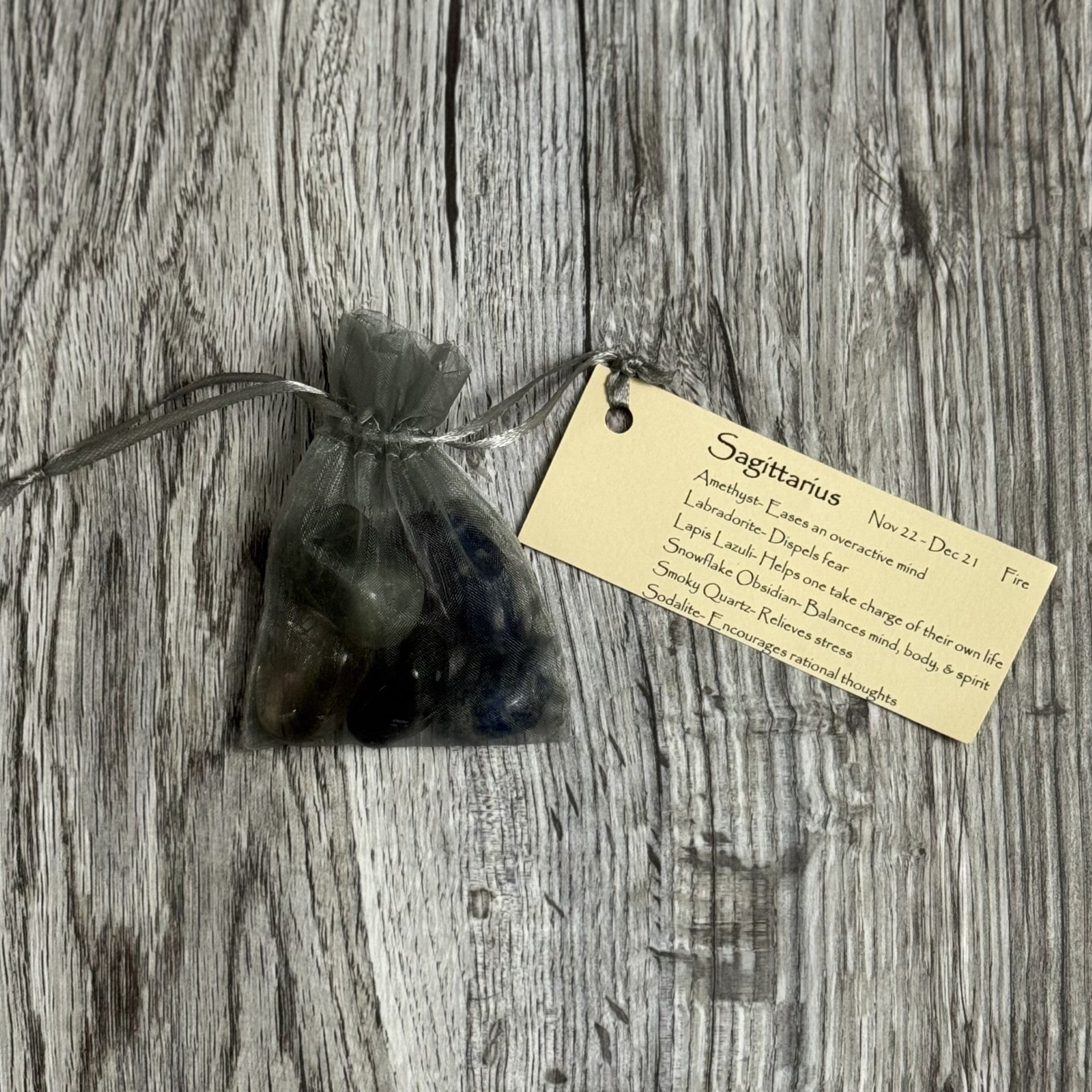 Bag of stones with a tag on a wooden surface