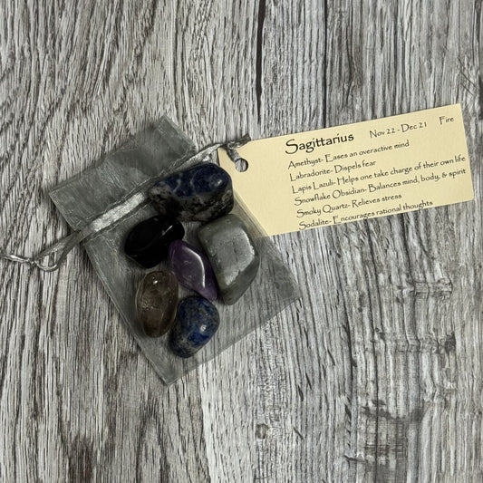 Set of stones in a clear bag with a label on a wooden surface