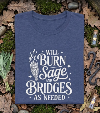 Folded Heather True Royal blue 'Will burn sage and bridges' tee styled on a natural earthy background