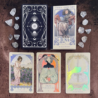 Tarot cards from the 'Ethereal Visions Tarot Luna Edition' with decorative box and crystals on a dark surface.