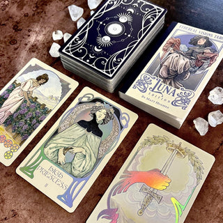 Collection of tarot cards with detailed artwork on a wooden surface.